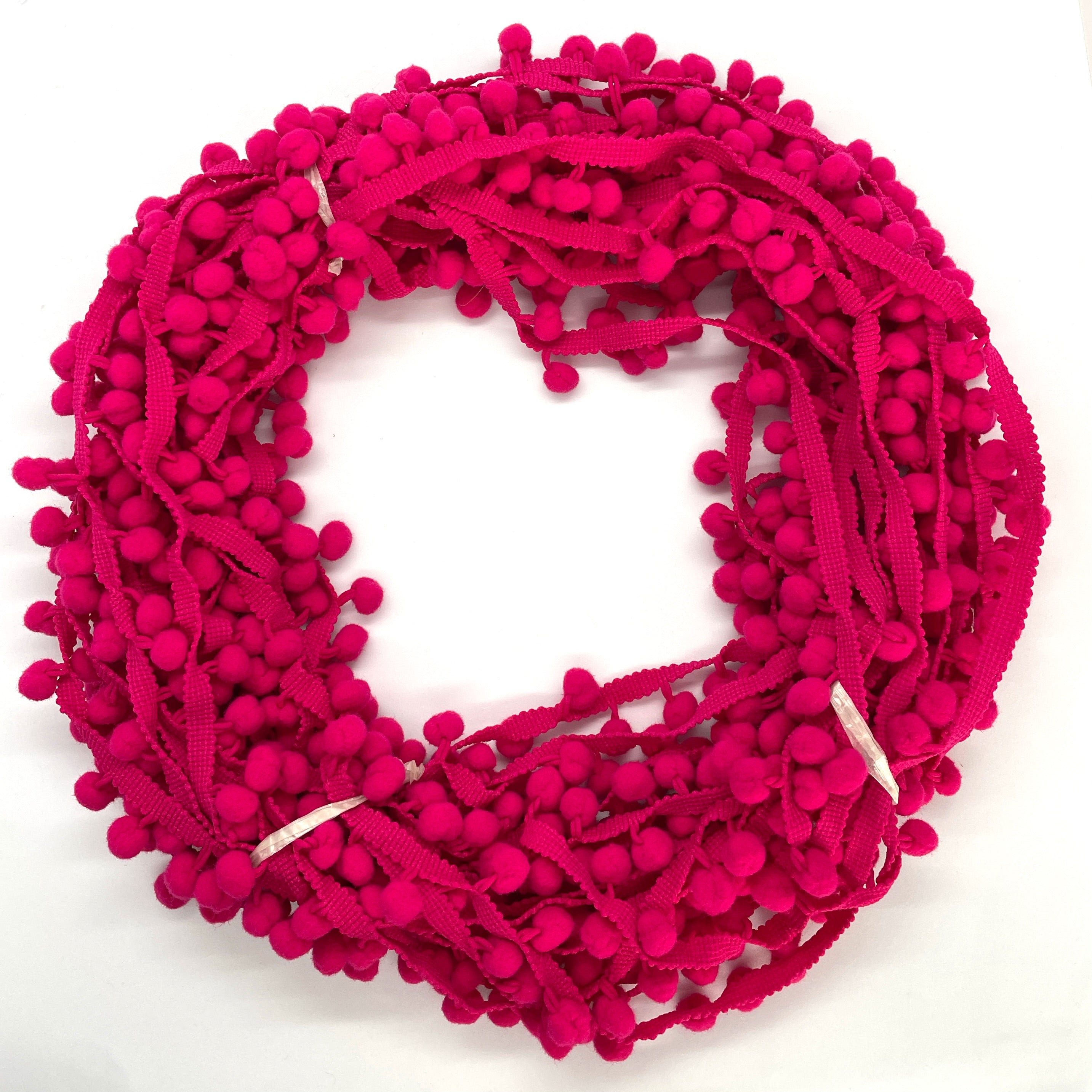 cerise pom pom trim idea for cushions, curtains or anywhere that needs a little extra wow