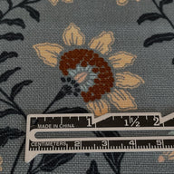 waterproof floral canvas fabric on a slate grey blue backgroun. Pretty flowers that look embroidered on