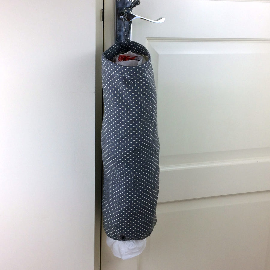plastic bag dispenser and holder for those pesky bags for life that take over this one is a grey spotted canvas fabric