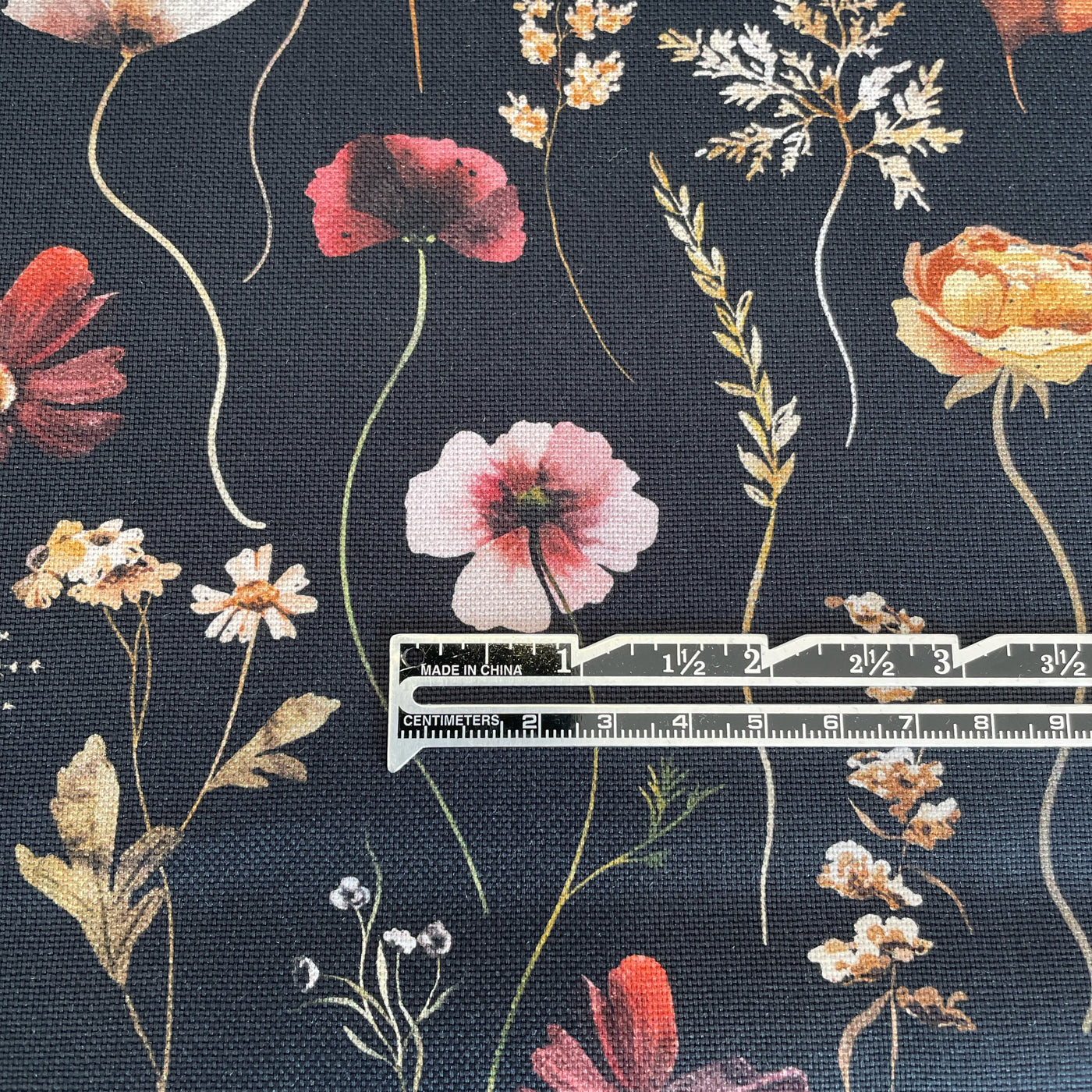 This stunning digitally printed 100% cotton floral design on a black background canvas &nbsp; It is a hardwearing Cotton woven canvas fabric, ideal for clothes, canvas bags, upholstery, etc