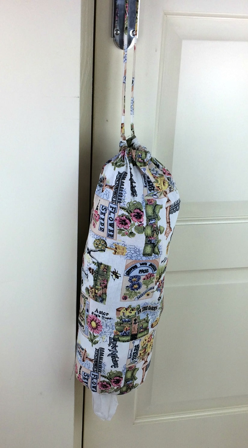 plastic bag dispenser and holder for those pesky bags for life that take over this one is green gardening theme