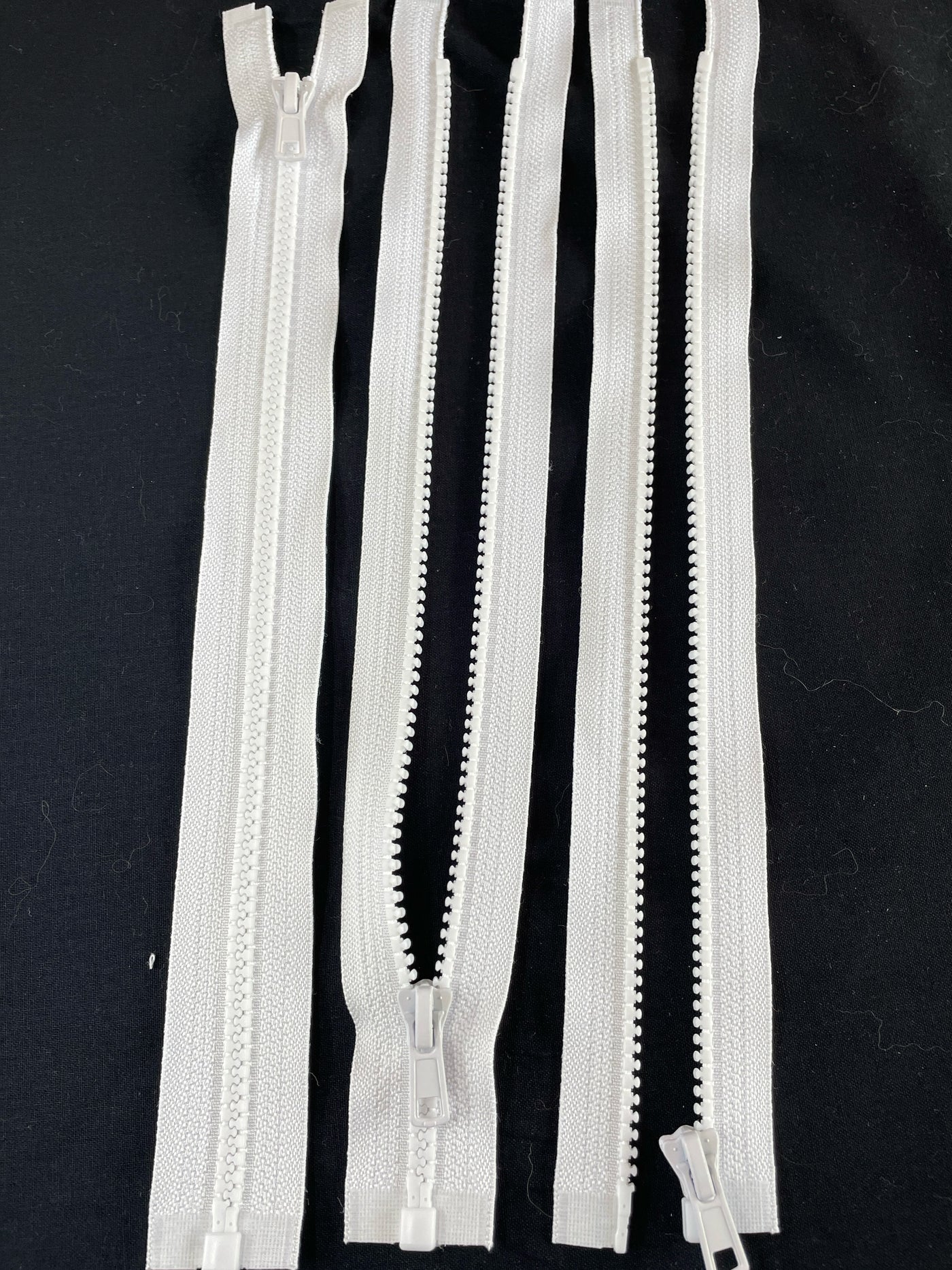 white Chunky open-ended zippers in Size 5: Robust and reliable zippers designed for heavy-duty applications. The chunky design ensures durability and strength, suitable for projects requiring sturdy closures. With open-ended functionality, they offer accessibility and ease of use for jackets, bags, and outdoor gear. Size 5 provides ample width for secure fastening, making these zippers ideal for projects that demand both style and substance.