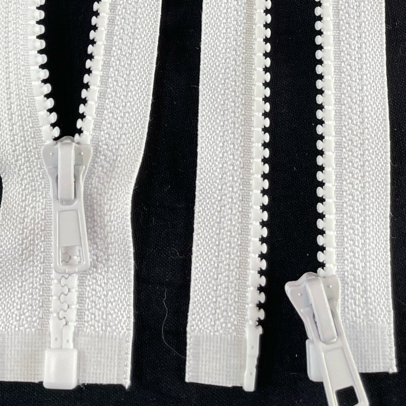 white Chunky open-ended zippers in Size 5: Robust and reliable zippers designed for heavy-duty applications. The chunky design ensures durability and strength, suitable for projects requiring sturdy closures. With open-ended functionality, they offer accessibility and ease of use for jackets, bags, and outdoor gear. Size 5 provides ample width for secure fastening, making these zippers ideal for projects that demand both style and substance.