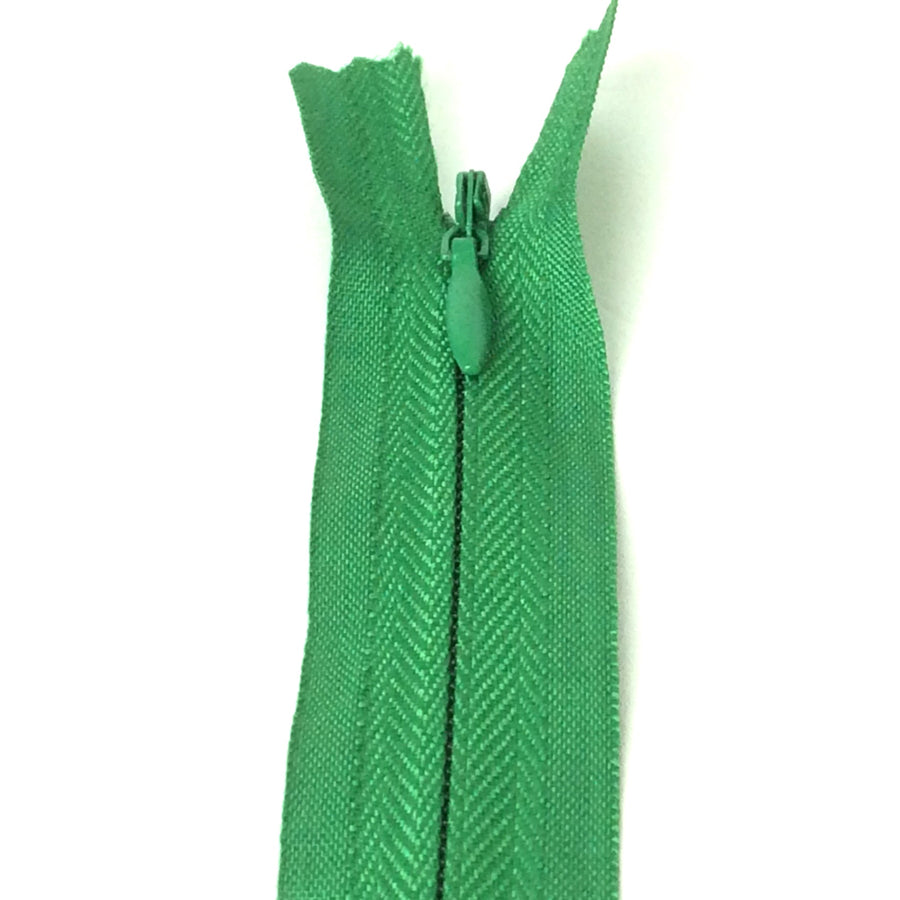 Photo of emerald green invisible or concealed zips available in many different colours and sizes. Great for achieving a professional finish in your products. Invisible zippers are perfect for dressmaking, cushions, crafts, etc., where you don't want your zipper showing. Installing them can be tricky without the right foot on your machine; a normal zipper foot is for installing standard zippers, while you will need an invisible zipper foot for a professional result