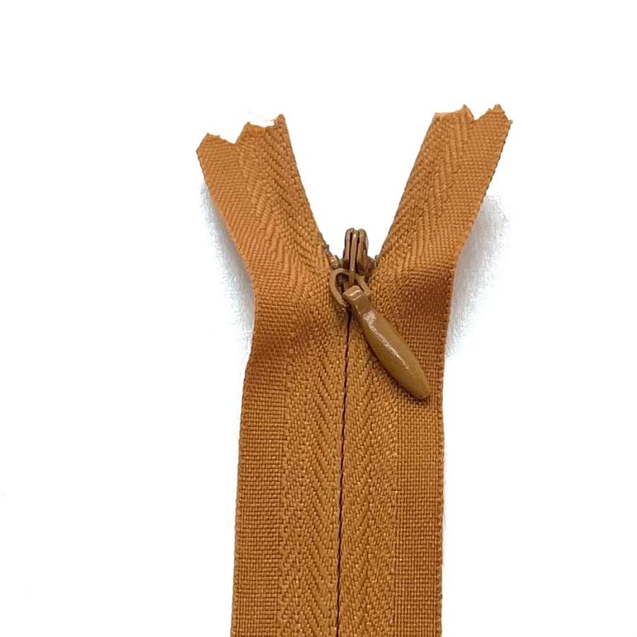 Photo of autumn gold  invisible or concealed zips available in many different colors and sizes. Great for achieving a professional finish in your products. Invisible zippers are perfect for dressmaking, cushions, crafts, etc., where you don't want your zipper showing. Installing them can be tricky without the right foot on your machine; a normal zipper foot is for installing standard zippers, while you will need an invisible zipper foot for a professional result