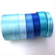 stack of blues and turquoise single faced ribbon for crafts