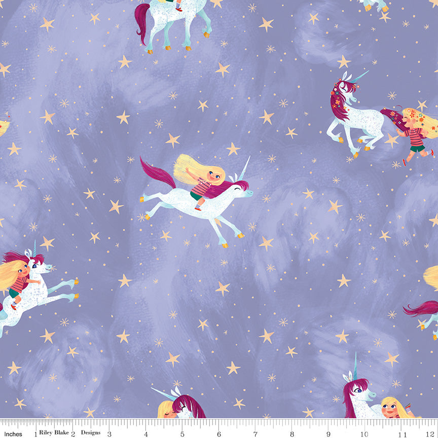 Riley Blake Unicorn fabric on a light purple background.  Blonde child playing and riding the unicorns with stars dotted around