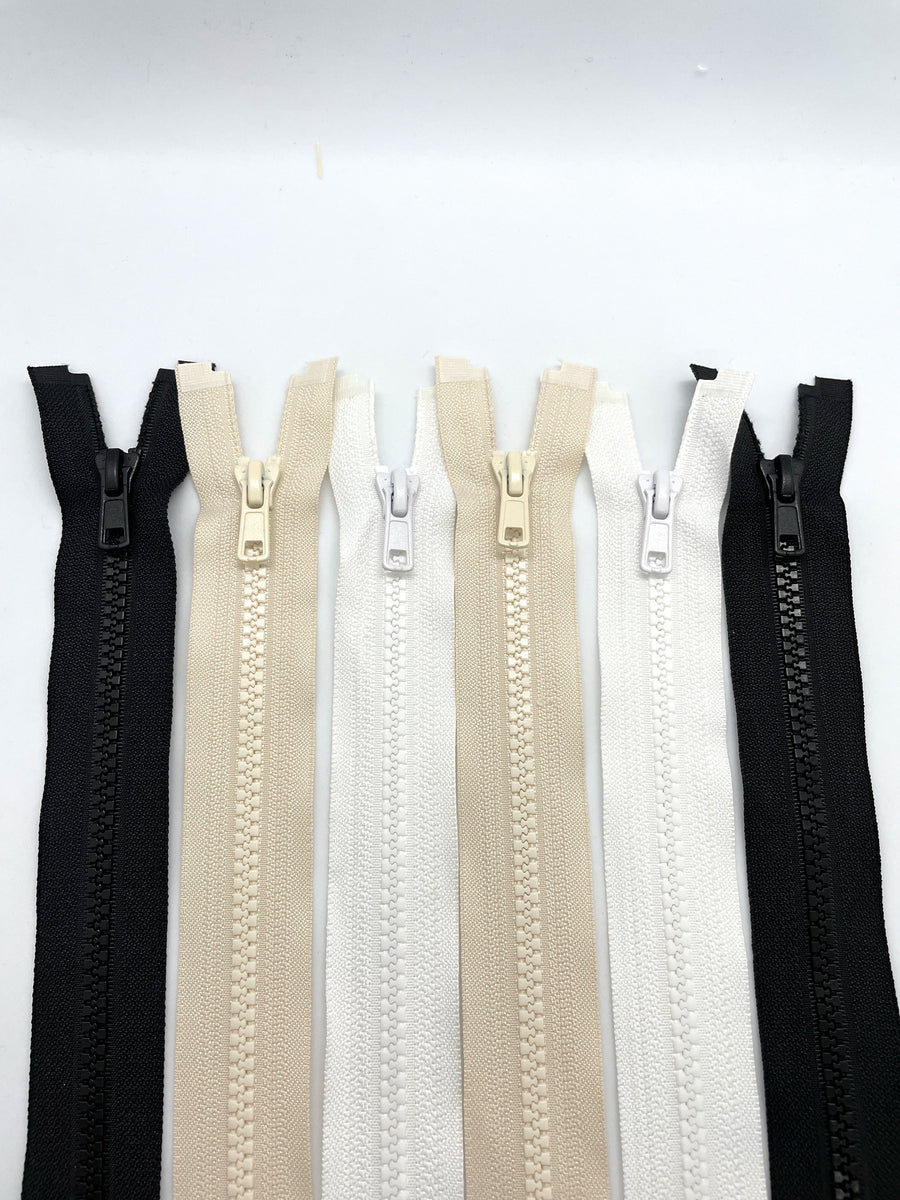 Chunky open zippers in black, white and neutral colours