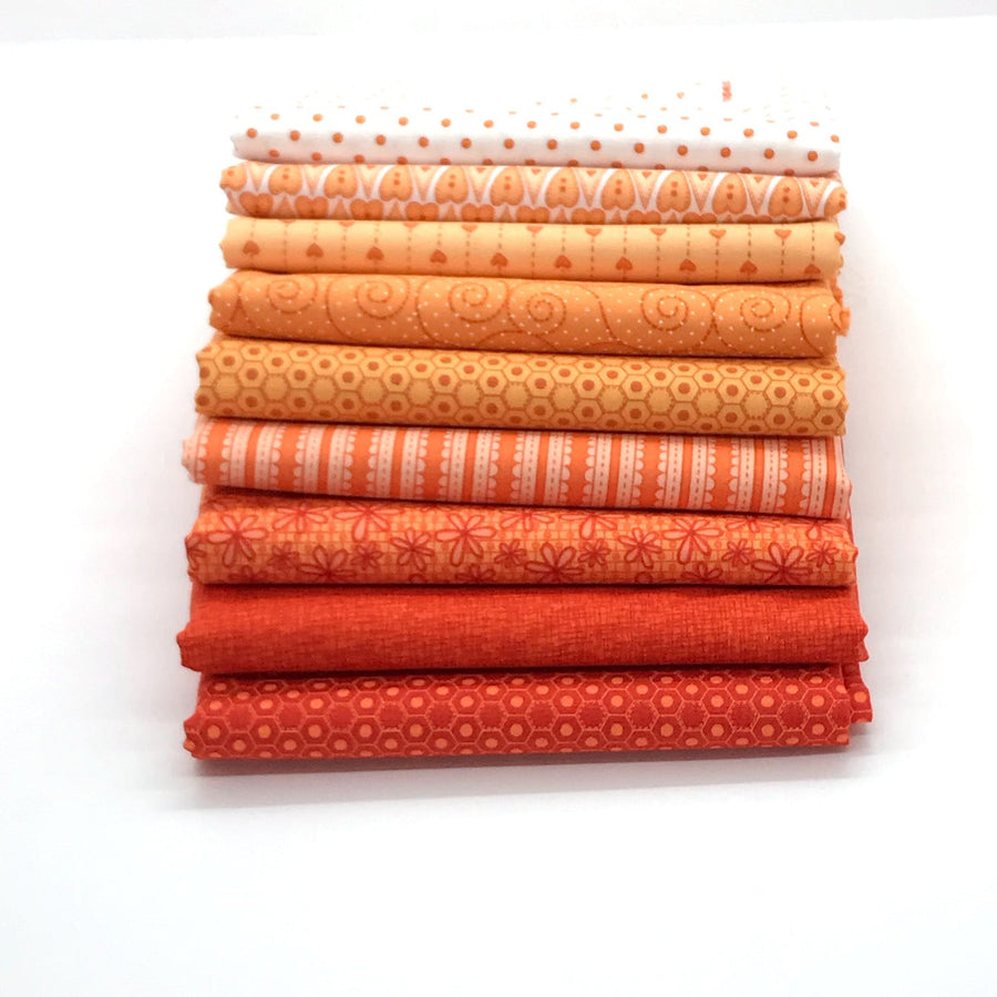 Photo of orange fat quarter bundle in basically hugs red rooster collection