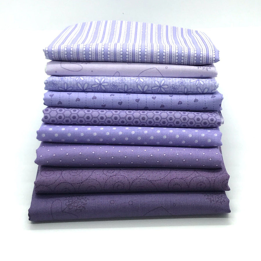 Photo of a bundle of purple fat quarters in the Red Rooster basically hugs collection