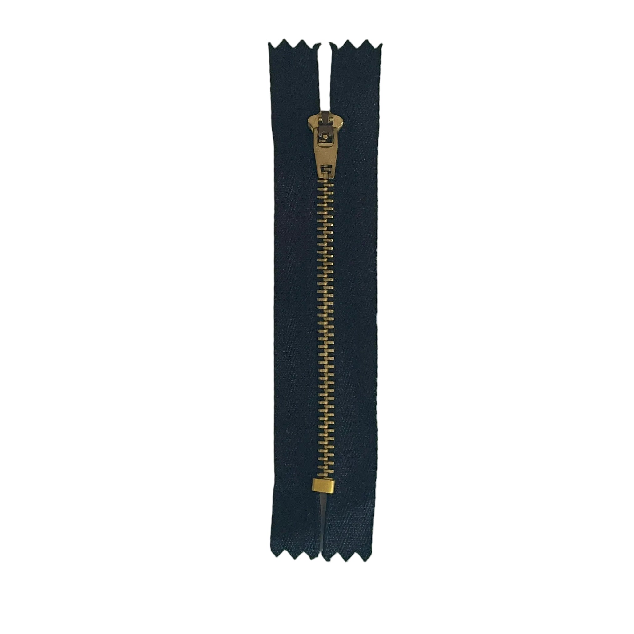 A single black  zipper with a gold-toned metal pull and teeth, laid flat on a white sheet of paper.