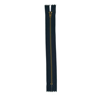 A single dark teal zipper with a gold-toned metal pull tab, shown vertically on a textured white paper background.