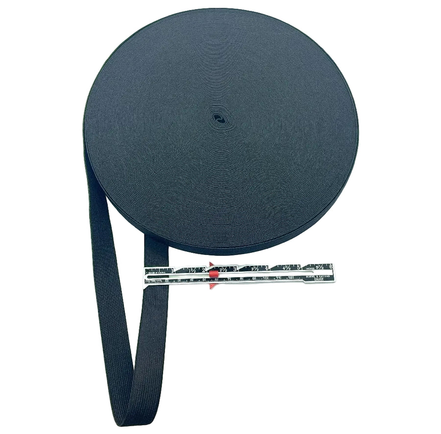 Roll of black 2cm elastic with a measuring tape for scale on a white background
