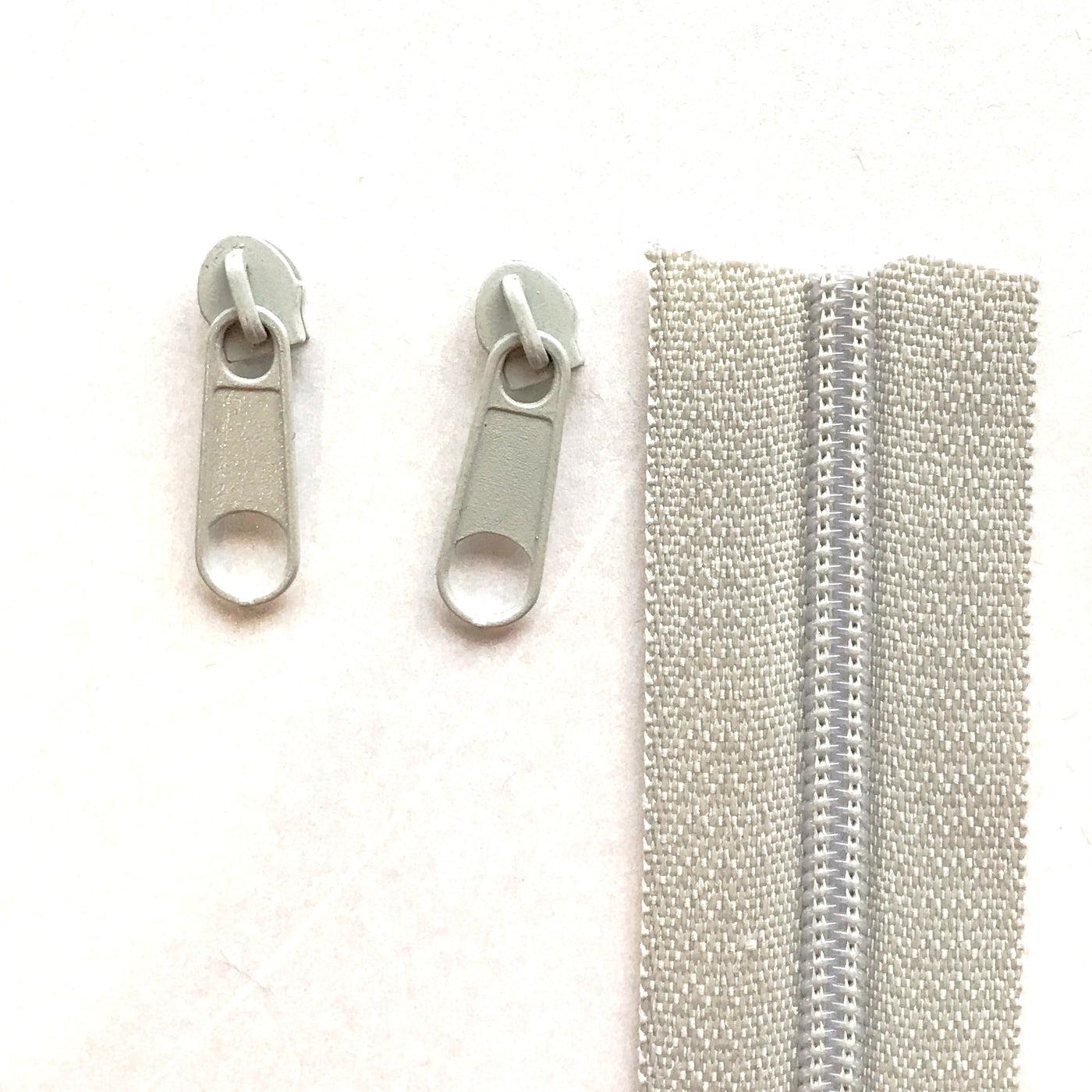 Light grey continuous long chain zipper tape and sliders