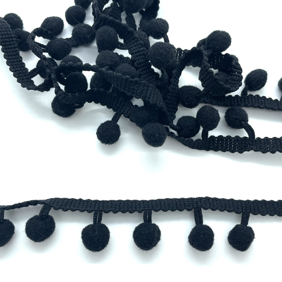 black pom pom trim idea for cushions, curtains or anywhere that needs a little extra wow