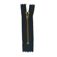 A single black jean zipper with a gold-tone metal pull tab