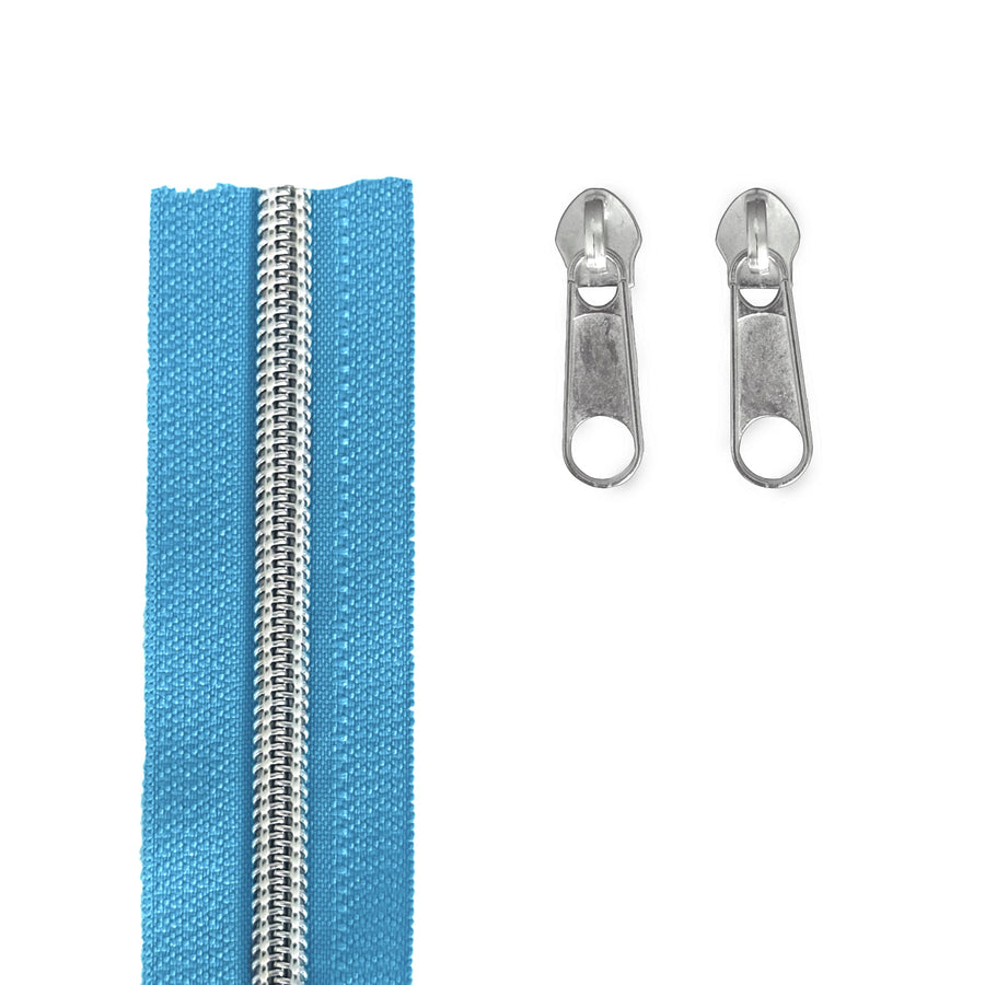 A light blue zipper shown vertically on the left, with two silver metal zipper pulls on the right, photographed on a plain white background.