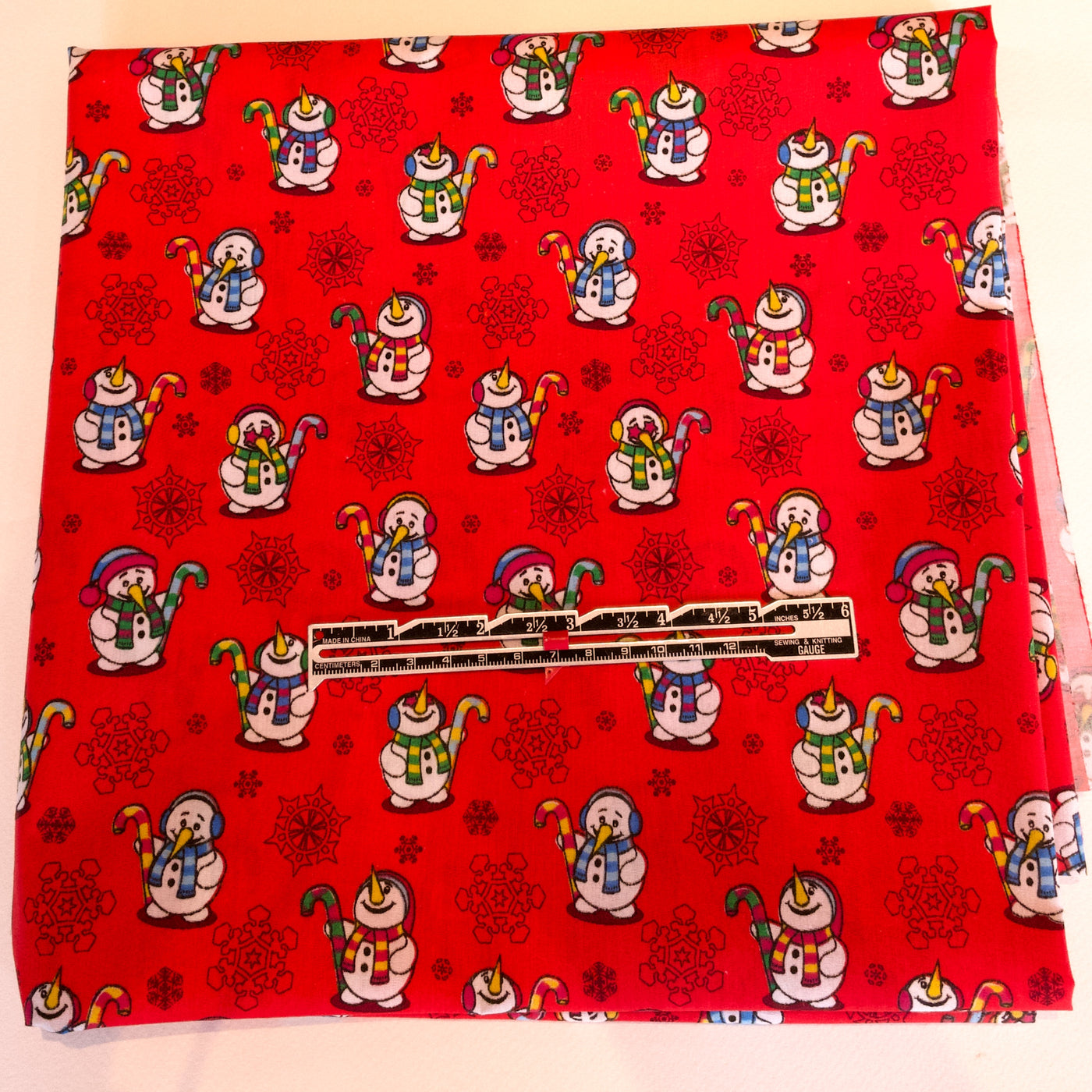 Red fabric with snowman design on a white background