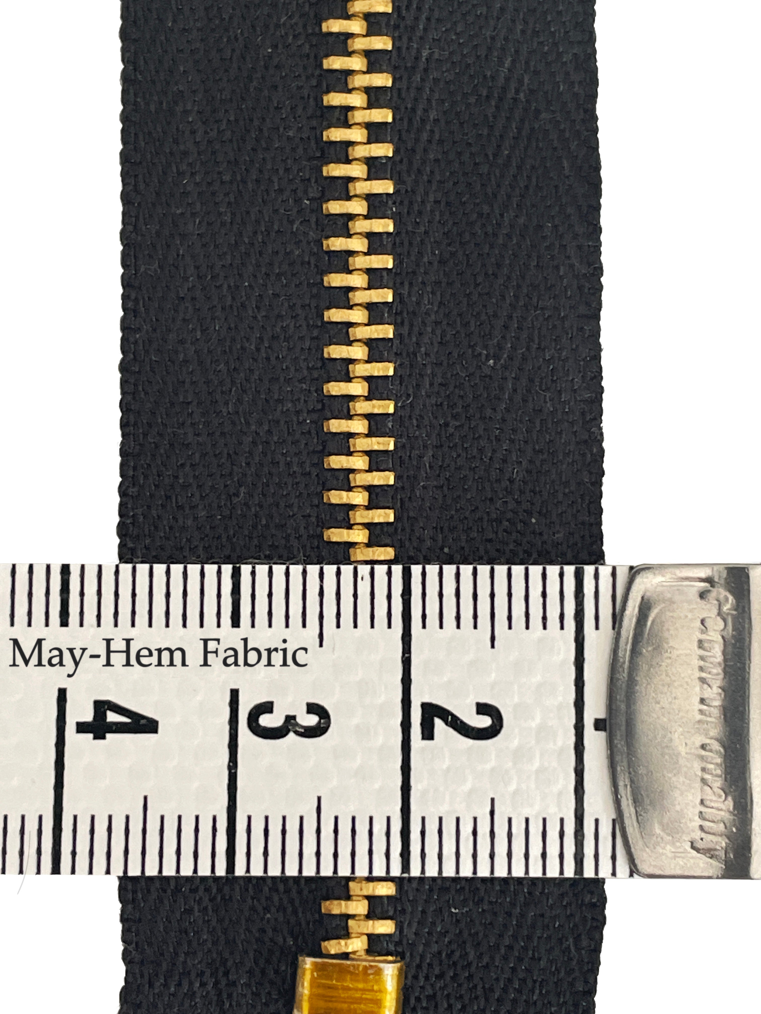 Close up of black metal jeans zip with tape measure showing the teeth size