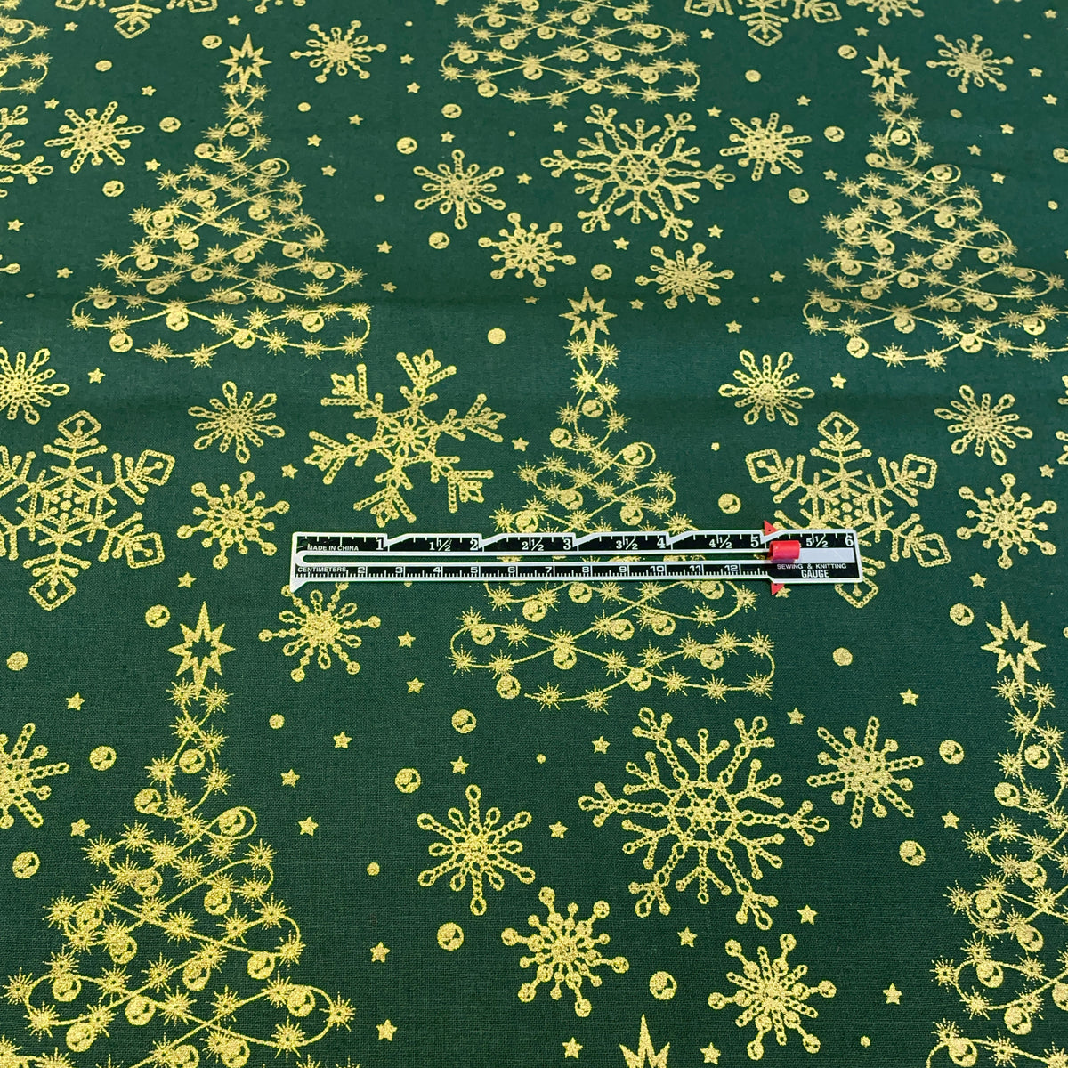 measuring the christmas trees on the green background.