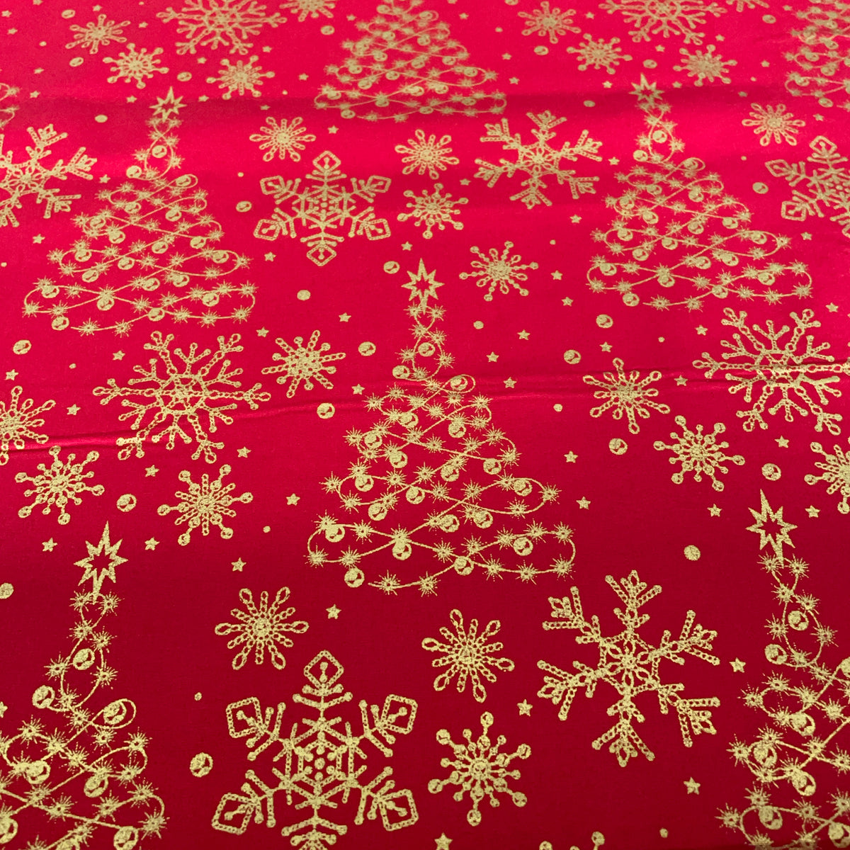 red cotton with printed golden christmas trees and snowflakes