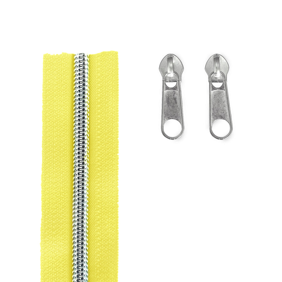 A bright yellow zipper shown vertically on the left, with two silver metal zipper pulls on the right, photographed on a plain white background.