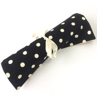 rolled up knitting needle roll from black fabric and ribbon