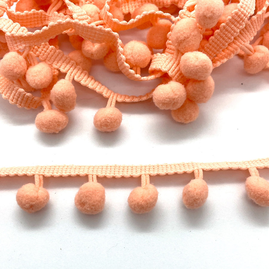 coral pom pom trim for embellishing your projects