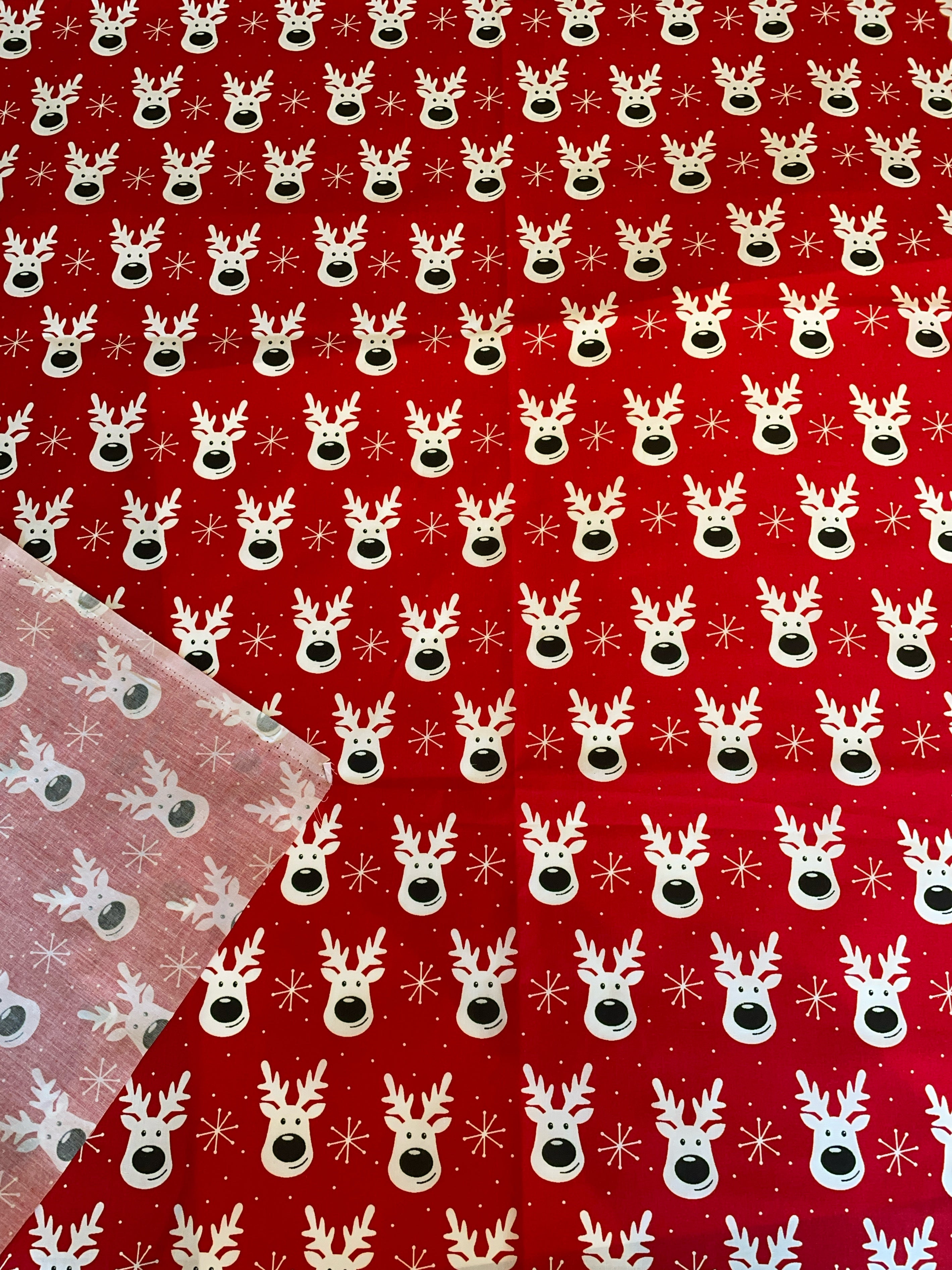 Red fabric with white reindeer pattern