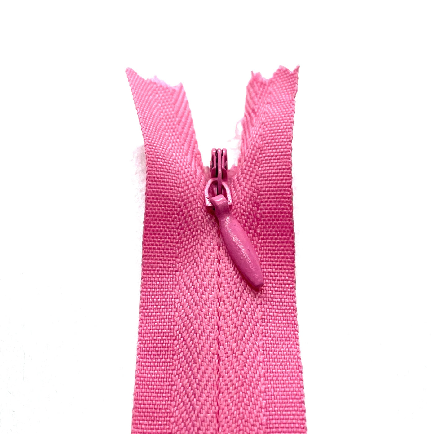 Photo of holiday pink invisible or concealed zips available in many different colours and sizes. Great for achieving a professional finish in your products. Invisible zippers are perfect for dressmaking, cushions, crafts, etc., where you don't want your zipper showing. Installing them can be tricky without the right foot on your machine; a normal zipper foot is for installing standard zippers, while you will need an invisible zipper foot for a professional result
