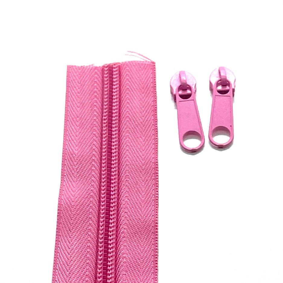 Photo of  holiday pink continuous zipper rolls in size 5, available in various colors. Matching sliders/zipper heads included at 2 per meter. Size 5 refers to the size of the coils when closed at 5mm