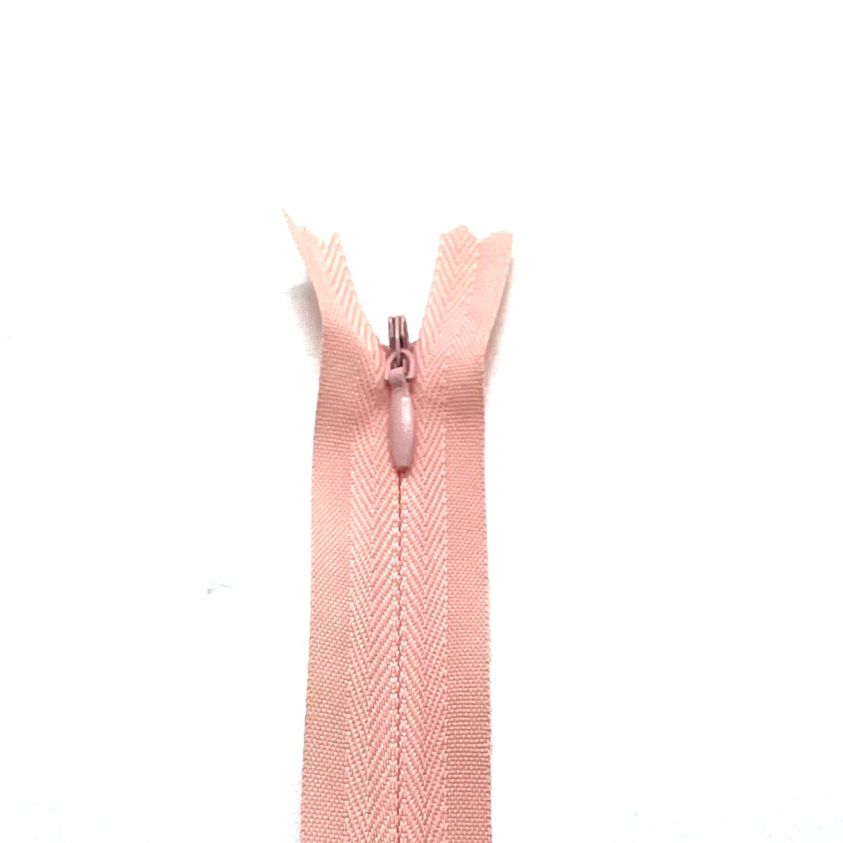 Photo of coral invisible or concealed zips available in many different colours and sizes. Great for achieving a professional finish in your products. Invisible zippers are perfect for dressmaking, cushions, crafts, etc., where you don't want your zipper showing. Installing them can be tricky without the right foot on your machine; a normal zipper foot is for installing standard zippers, while you will need an invisible zipper foot for a professional result