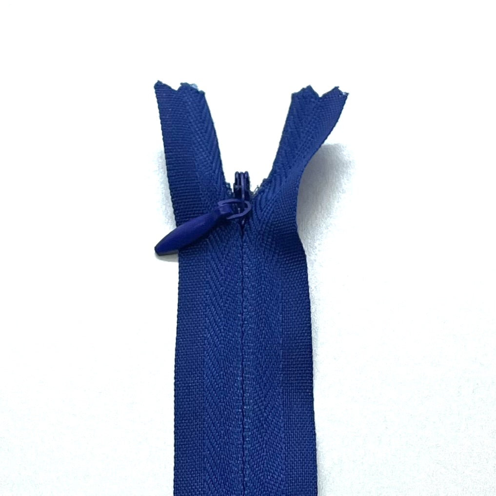 Photo of peacock blue invisible or concealed zips available in many different colours and sizes. Great for achieving a professional finish in your products. Invisible zippers are perfect for dressmaking, cushions, crafts, etc., where you don't want your zipper showing. Installing them can be tricky without the right foot on your machine; a normal zipper foot is for installing standard zippers, while you will need an invisible zipper foot for a professional result