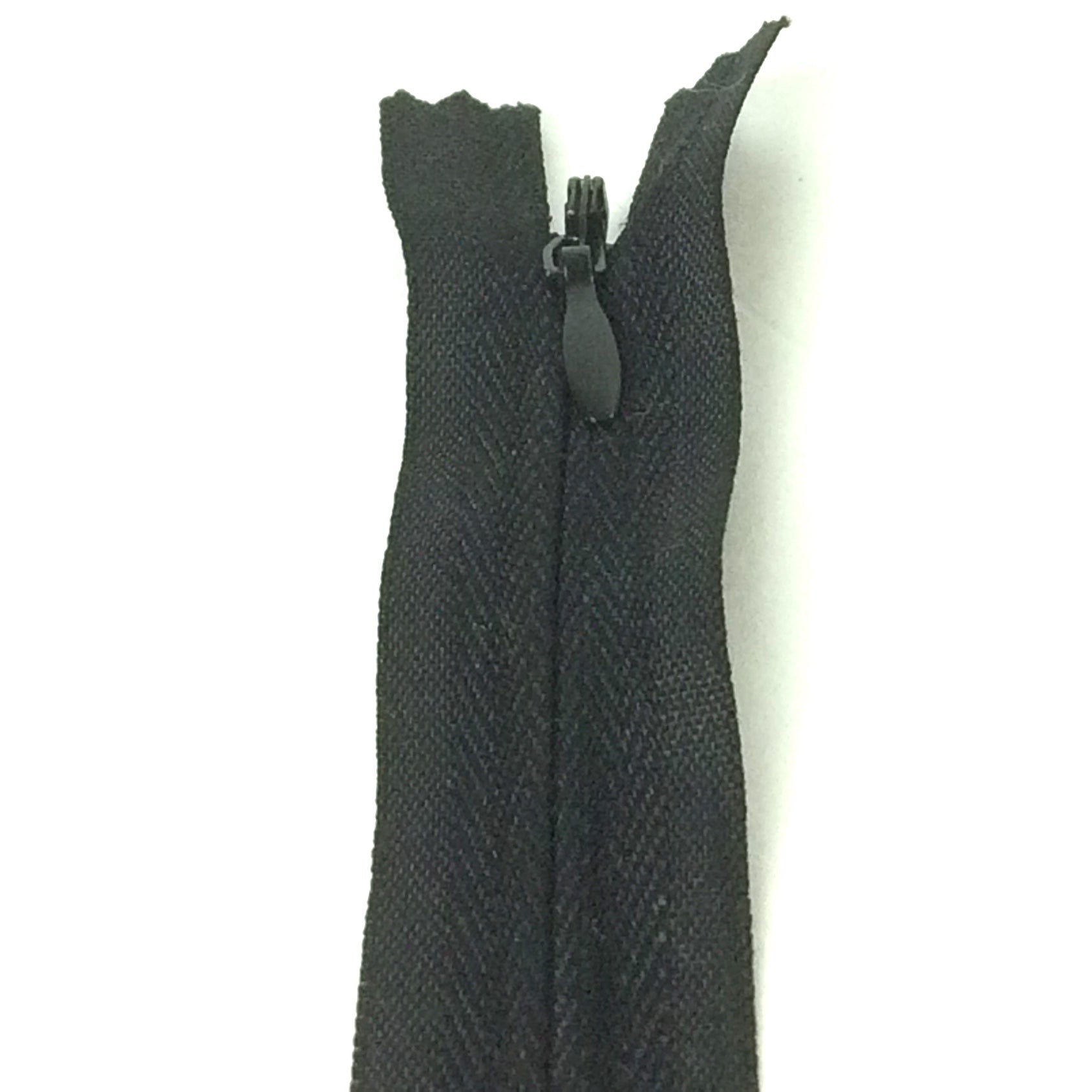 Photo of black invisible or concealed zips available in many different colours and sizes. Great for achieving a professional finish in your products. Invisible zippers are perfect for dressmaking, cushions, crafts, etc., where you don't want your zipper showing. Installing them can be tricky without the right foot on your machine; a normal zipper foot is for installing standard zippers, while you will need an invisible zipper foot for a professional result