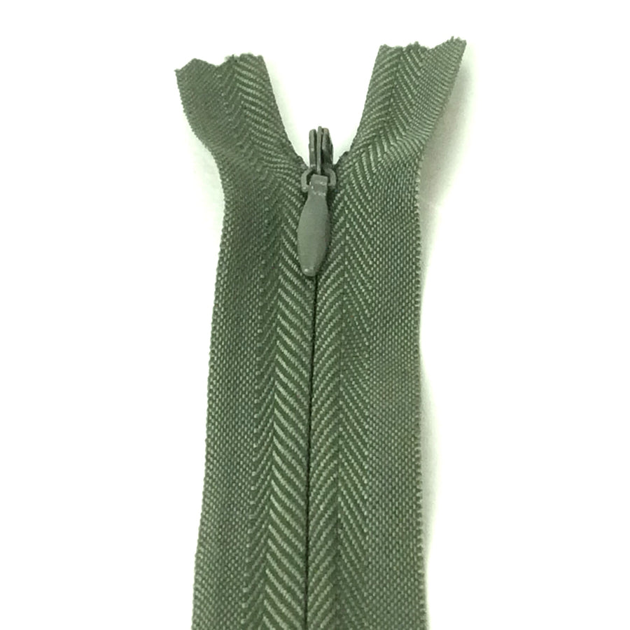 Photo of dark  olive green invisible or concealed zips available in many different colours and sizes. Great for achieving a professional finish in your products. Invisible zippers are perfect for dressmaking, cushions, crafts, etc., where you don't want your zipper showing. Installing them can be tricky without the right foot on your machine; a normal zipper foot is for installing standard zippers, while you will need an invisible zipper foot for a professional result