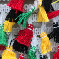 Black, yellow red and green tassle fringe trim