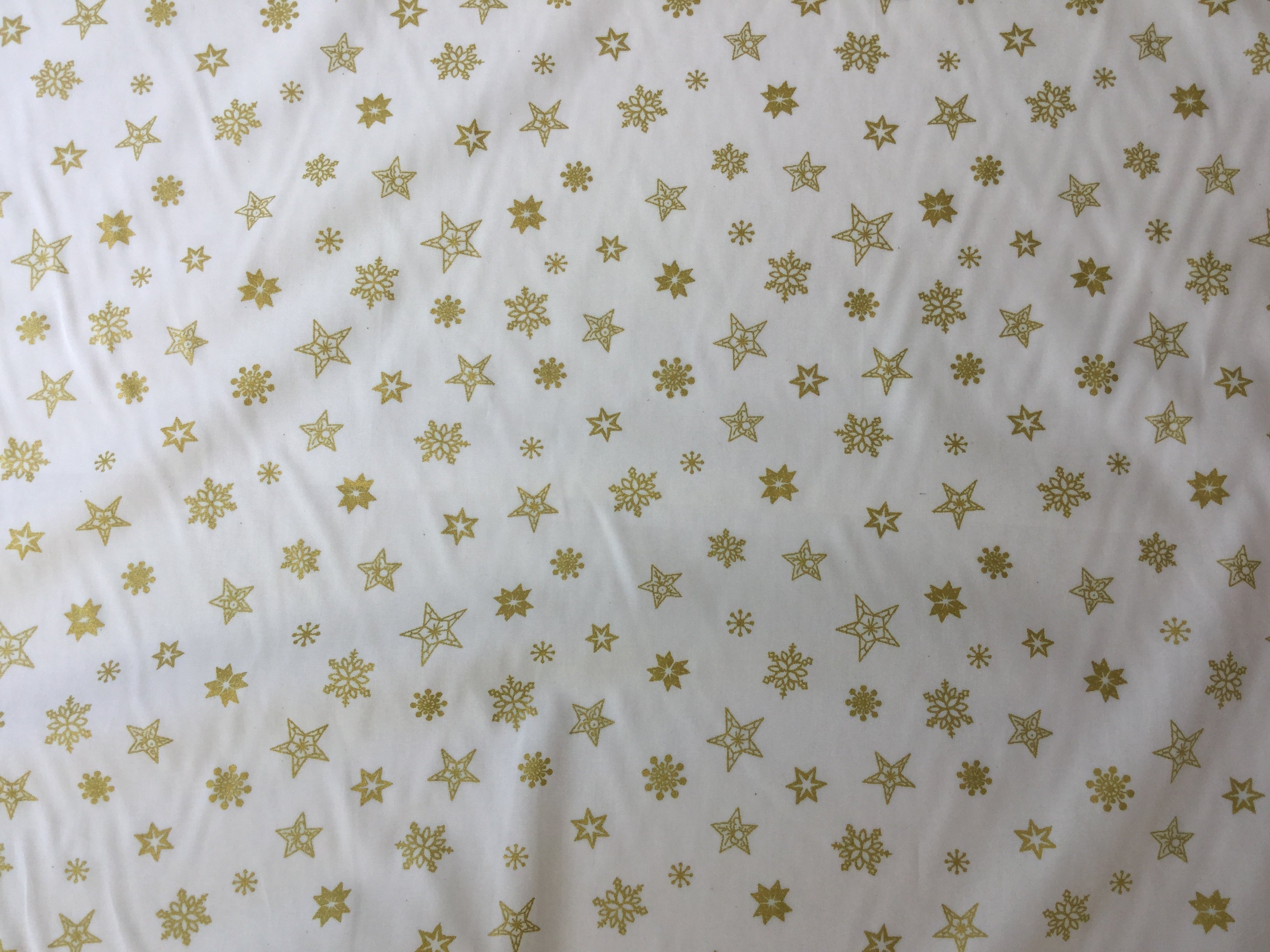 Rose and hubble gold stars cotton fabric with a festive theme