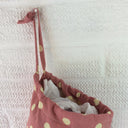 Plastic bag dispenser, dusky pink with large spots and a draw string