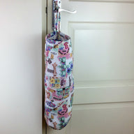Plastic bag dispenser with a garden theme in pink with draw string and elastic bottom