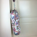 Plastic bag dispenser with a garden theme in pink with draw string and elastic bottom