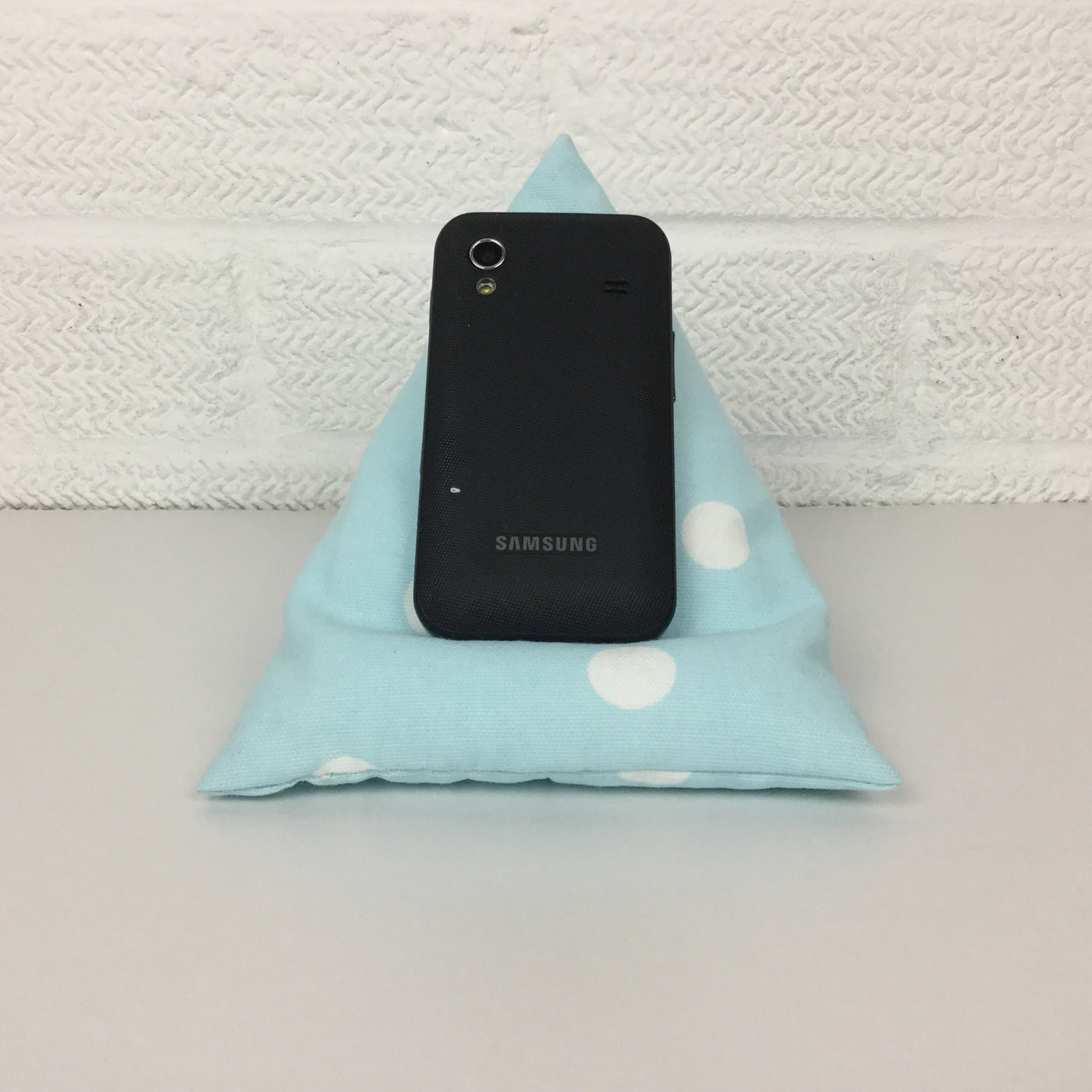A handy little phone holder keeps your phone where you want it.&nbsp; Made from cotton canvas and filled with polystyrene beads it has a lovely feel