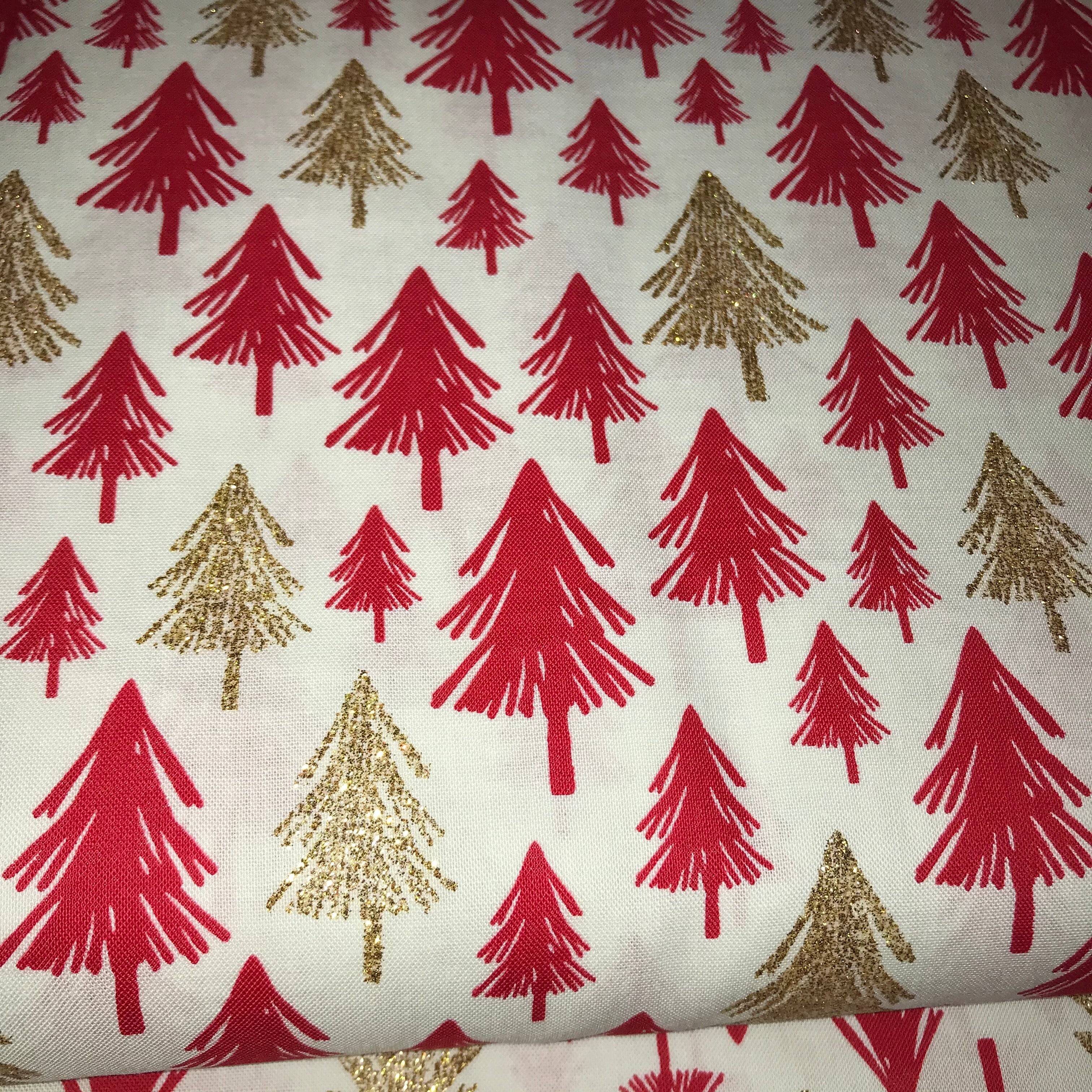 Glittery christmas trees on a cream background cotton fabric