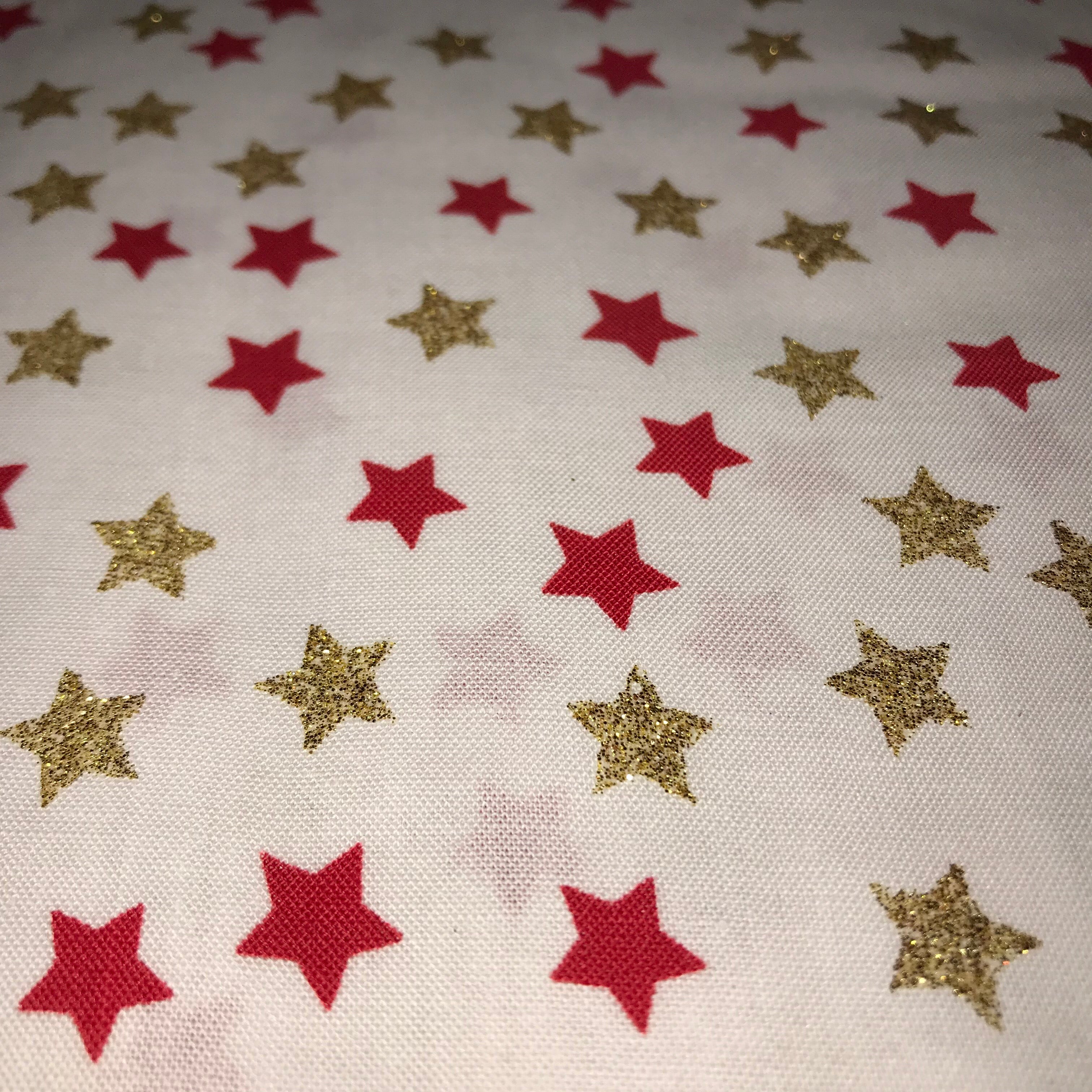glitter gold stars with red stars on a cream background cotton fabric