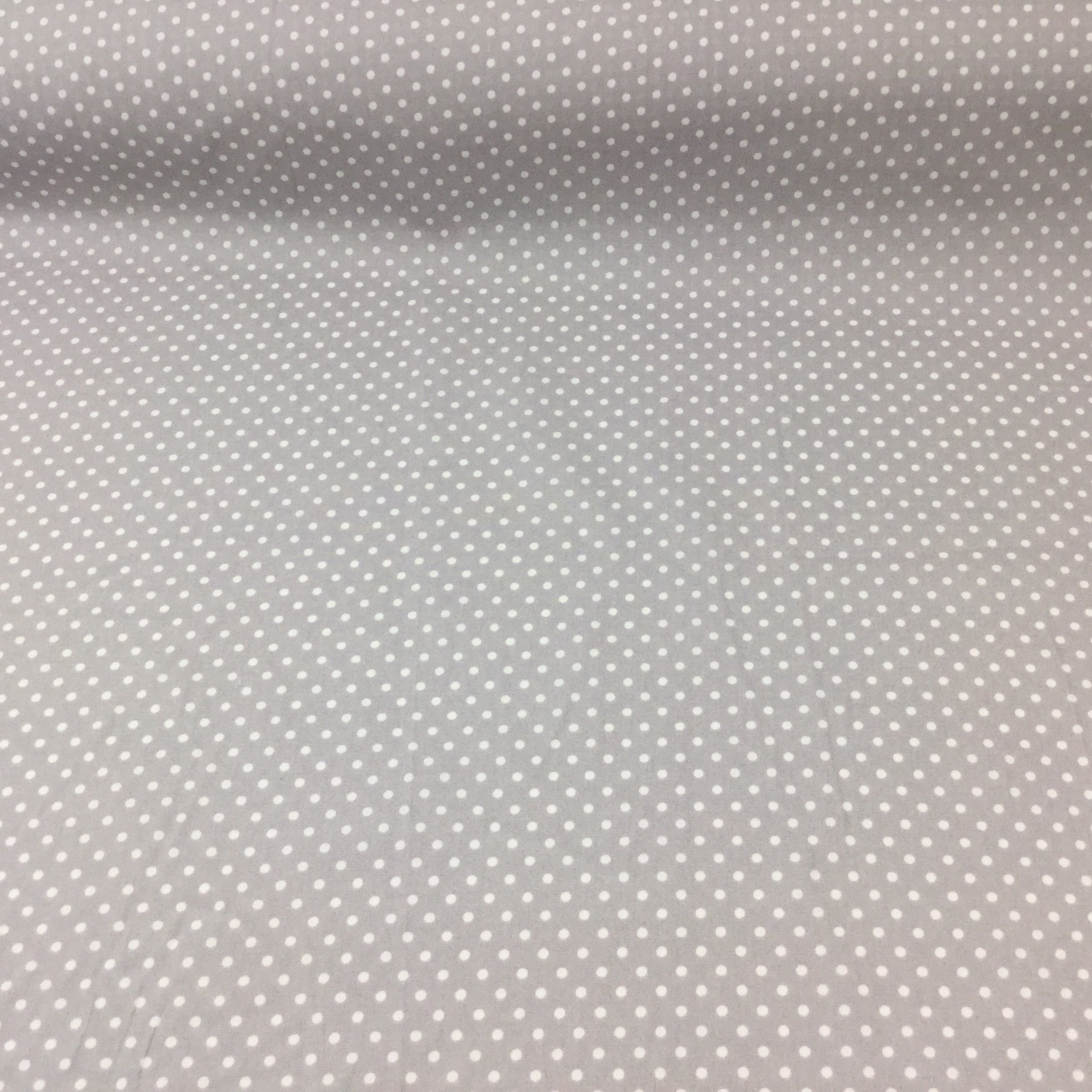 silver or grey spotted cotton fabric by rose and hubble