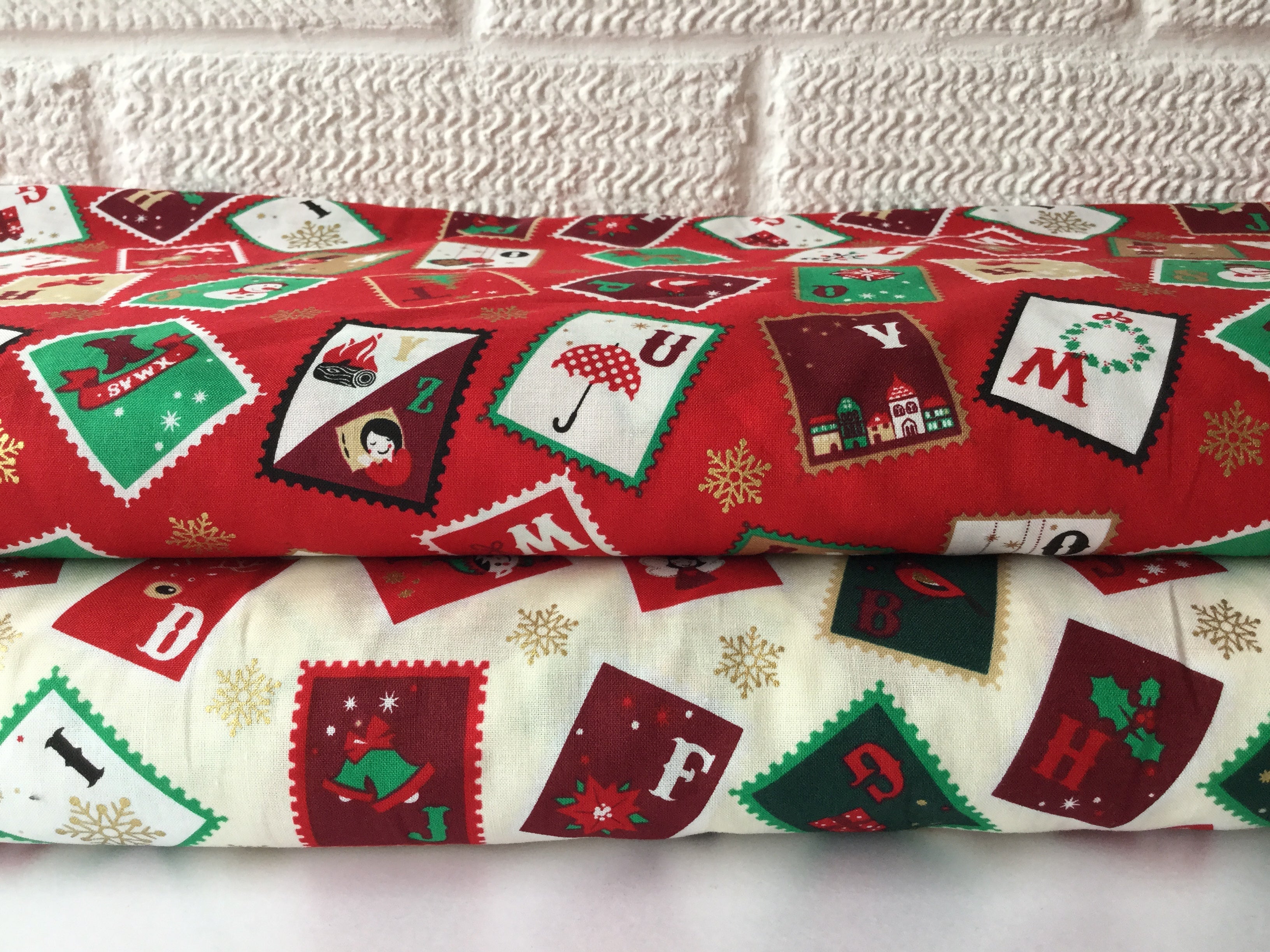 Christmas cotton fabrics with a festive stamps theme