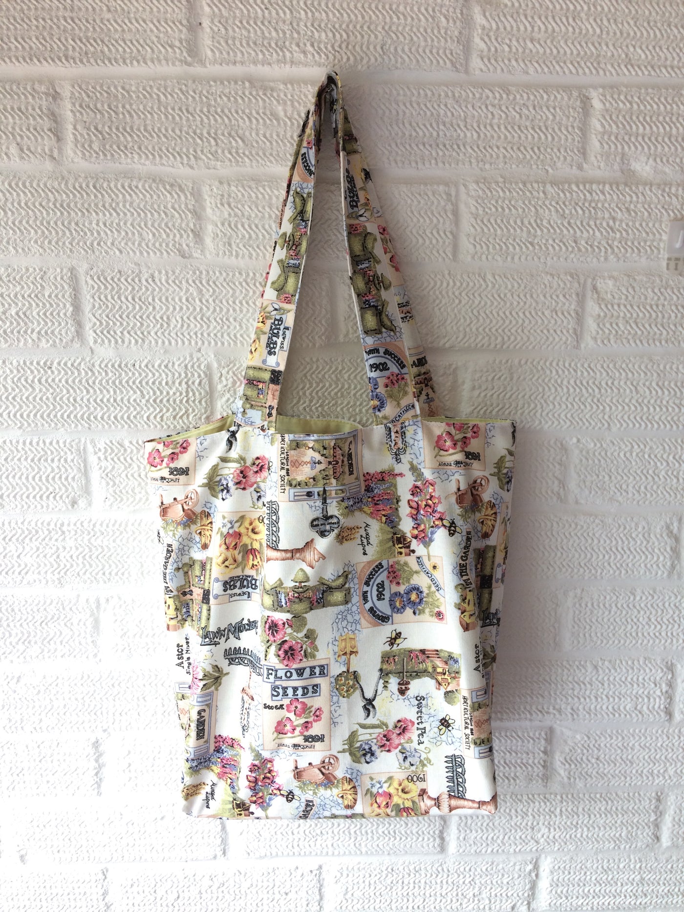 Green gardening themed tote bag with white lining